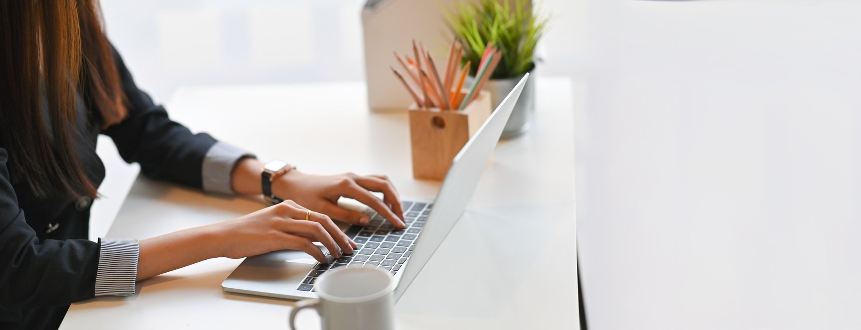 Woman Typing on a Laptop 